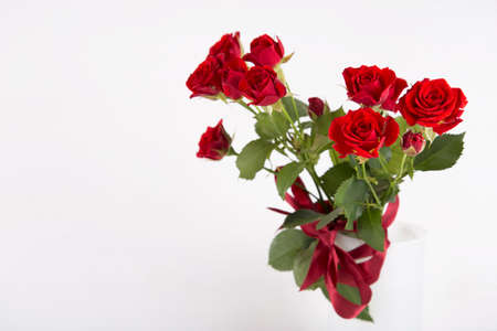 Bouquet of red roses in vase on white background.の写真素材