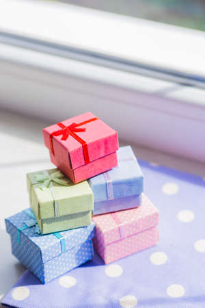 Colorful gift boxes on spotted fabric near window. Spring composition.の写真素材