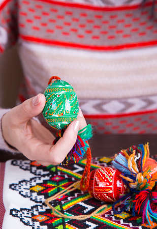 Colored easter eggs with traditional designs in female hands.の写真素材