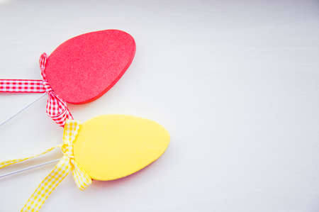 Two decorative colorful flat easter eggs on white background.の写真素材