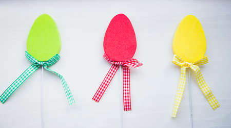Three decorative colorful flat easter eggs on white background.の写真素材