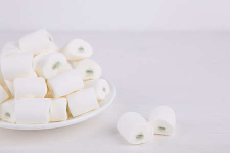 Close-up sweet apple marshmallow on plate on white background. Pastel composition.の写真素材