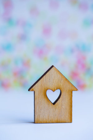 Wooden house with hole in form of heart on colorful background.の写真素材