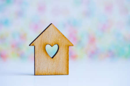 Wooden house with hole in form of heart on colorful background.の写真素材