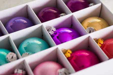 Colorful Christmas balls in white box. New Year holiday shopping. Package with xmas decoration.の写真素材