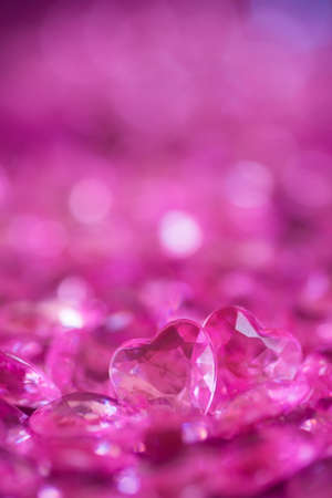 Two pink little crystal hearts on bokeh background. Romantic card on St. Valentine's Day.の写真素材