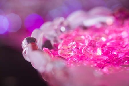 Many pink little glass hearts on crystal vase with bokeh background. Romantic card on St. Valentine's Dayの写真素材