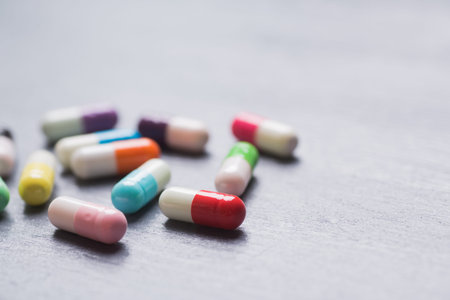 Diversity of colorful different capsules on gray background.の写真素材