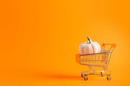 Toy shopping cart with gift boxes on white background with copy space. Black Friday banner, shopping concept. Sale idea.の写真素材