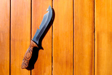 Camp knife for cooking on a wooden tableの写真素材