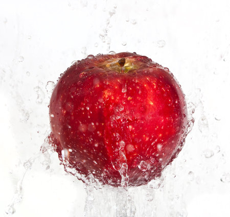 Fresh apple fall in water splashの写真素材