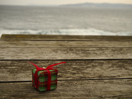 Gift on wood and the seaの写真素材