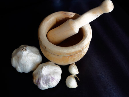 Mortar with a garlics on black backgroundの写真素材