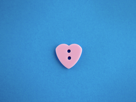 Pink button on blue backgroundの写真素材