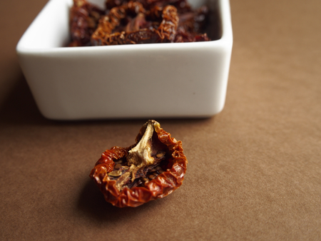 Dried tomatoes on brown backgroundの写真素材
