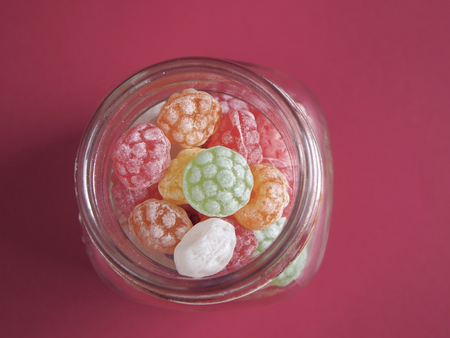 Canister of candies on red backgroundの写真素材
