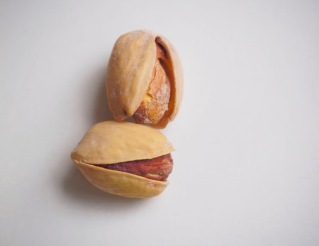 Two pistachios isolated on white background