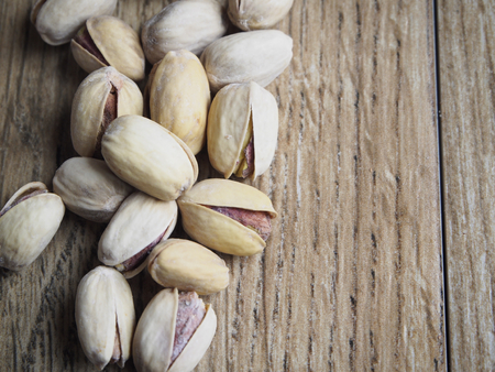 Group of pistachios on wood backgroundの写真素材