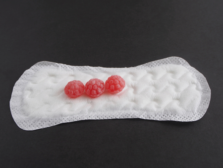 Compress on black background with red candiesの写真素材