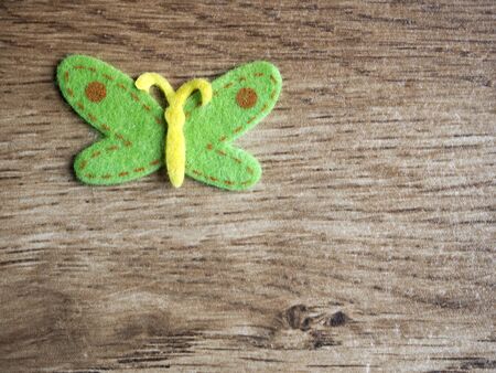 Felt butterfly on wood backgroundの写真素材
