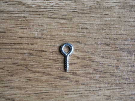 Eyebolt on wood backgroundの写真素材