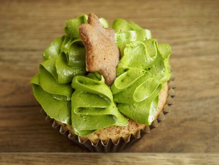 Cupcake with a star on wood backgroundの写真素材