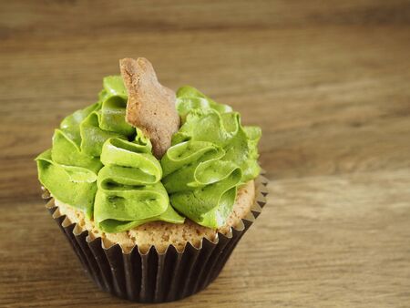 Cupcake with a star on wood backgroundの写真素材