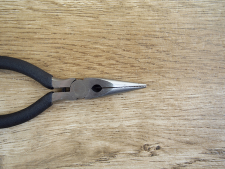 Pliers on wood backgroundの写真素材