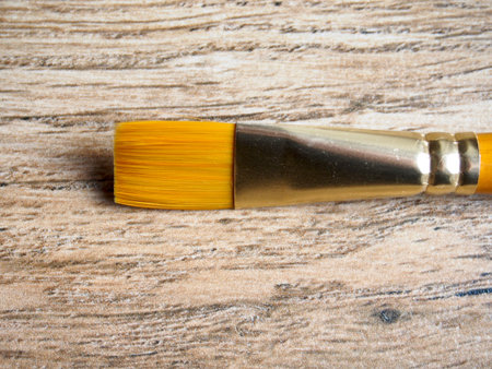 Paintbrush on wood background