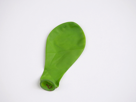 Green deflated balloon isolatedの写真素材