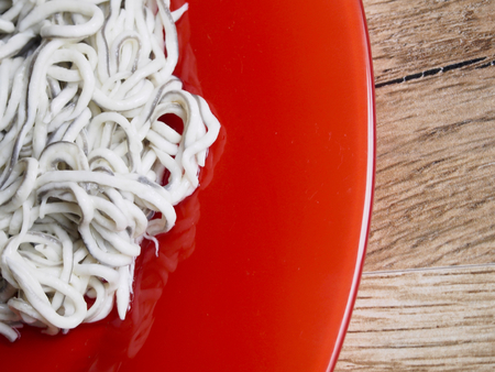 Baby eels on red plateの写真素材