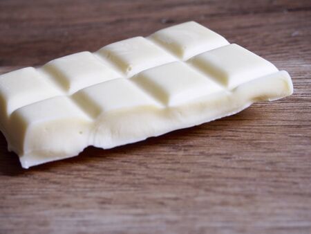 White chocolate on wood backgroundの写真素材