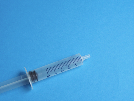 Syringe on blue backgroundの写真素材