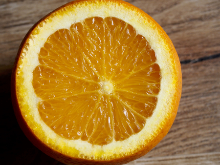 Half orange on wood backgroundの写真素材