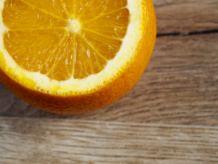 Half orange on wood backgroundの写真素材