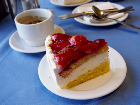 Strawberry cake with coffee on blue backgroundの写真素材