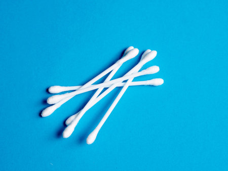 Cotton buds on blue background