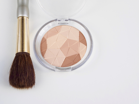 Compact powders and brush on white backgroundの写真素材