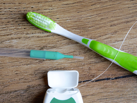 Dental floss, interdental brush and toothbrush on wood backgroundの写真素材