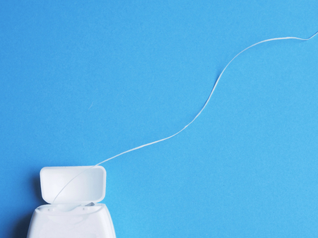 Dental floss on blue backgroundの写真素材