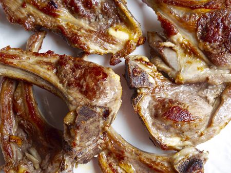 Cooked lamb chops  in a white dishの写真素材