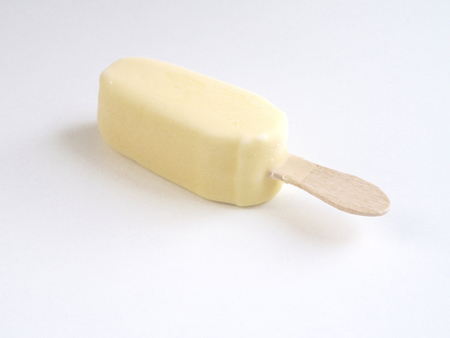Ice cream covered with white chocolate on white backgroundの写真素材