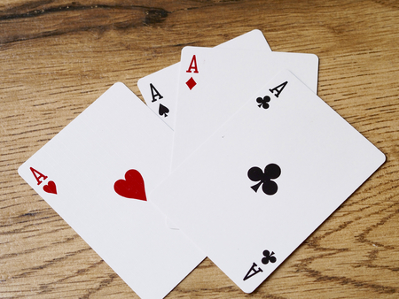Four aces cards on wood background - Success conceptの写真素材