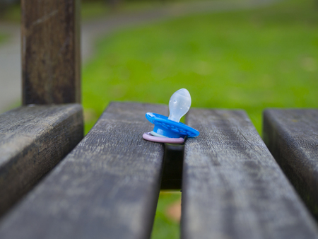 Pacifier baby lost in the gardenの写真素材