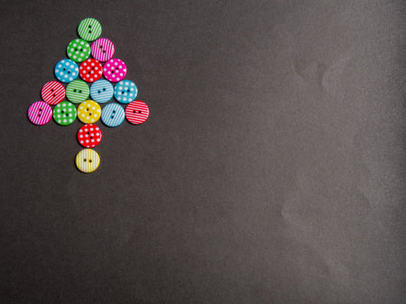Colorful bottons with tree shape on black background