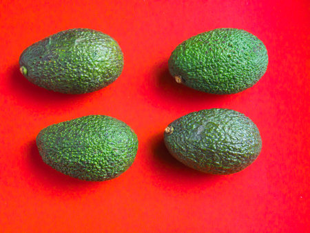 Avocados on red background