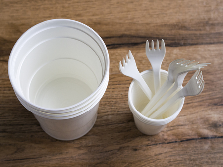 Plastic ware on wood backgroundの写真素材