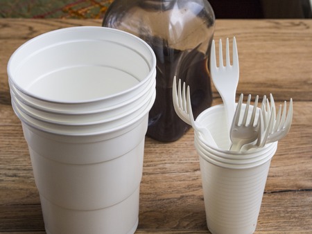 Plastic ware on wood backgroundの写真素材