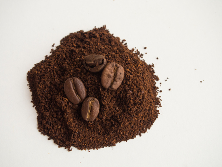 Ground coffee with coffee beans on white backgroundの写真素材