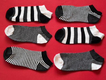 Black and white socks pattern on red backgroundの写真素材